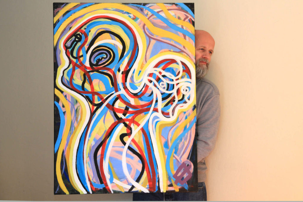A picture of the artwork called Despair by Eirik Østbakken. The artist is holding the picture.